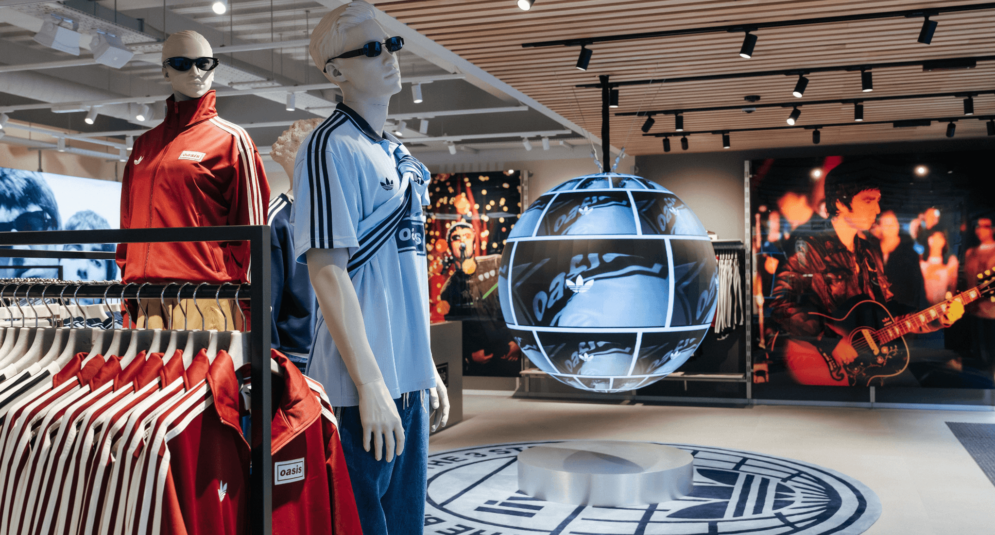 Interior of an Oasis clothing store featuring mannequins and a futuristic globe display.